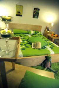 a bedroom with a green bed with a book on it at Idealodge B&B in Colleferro