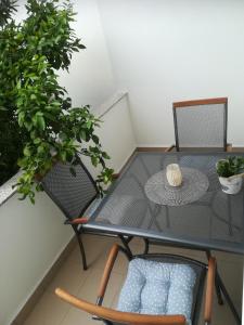 una mesa y sillas en un balcón con plantas en Filip 2, en Biograd na Moru