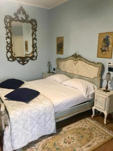 a bedroom with two beds and a mirror on the wall at B&B Villa Botto in Cossato
