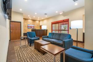 a waiting room with a couch and two chairs at Comfort Inn & Suites Harrisburg - Hershey West in Harrisburg