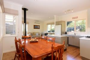 a kitchen and dining room with a wooden table and chairs at Bimbadeen Comfortable country styled house in Kangaroo Valley