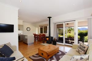 a living room with a couch and a fireplace at Bimbadeen Comfortable country styled house in Kangaroo Valley