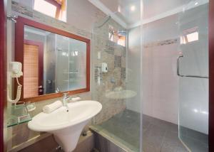 a bathroom with a sink and a glass shower at Gold Beach Resort in Flic-en-Flac +46 photos