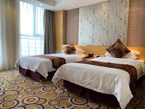 a hotel room with two beds and a window at Suzhou Sun Plaza Hotel in Suzhou