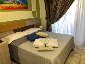 a bedroom with a bed with a tray of wine glasses at Agriturismo Casa Giusta in Centola