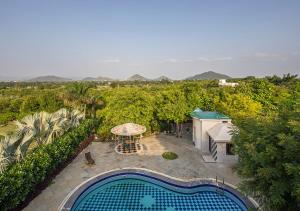 an overhead view of a backyard with a swimming pool at Wild Orchid by StayVista, 2 BHK villa with a swimming pool, spacious lawn & a gazebo for a perfect getaway in Udaipur