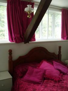 A bed or beds in a room at The Old Forge Seafood Restaurant and Bed and Breakfast 