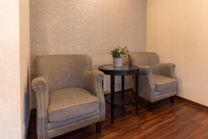 a waiting room with two chairs and a table at Bijou Suites Naniwa in Osaka