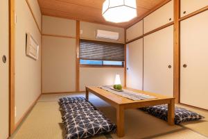 a meditation room with a table and a bench at Bijou Suites Naniwa in Osaka
