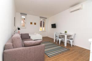 a living room with a couch and a table at Apartments and Rooms Jospino in Mali Lošinj