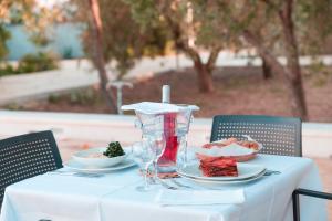 a white table with a plate of food on it at I Ruscioli in Torre Chianca