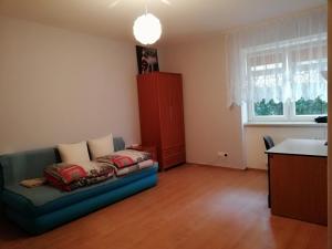 a living room with a couch and a window at Studia Pasieka in Opole