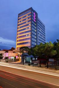 a tall building with a sign on the side of it at favehotel Manahan - Solo in Solo