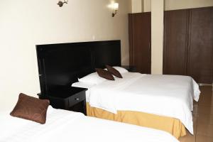Voodi või voodid majutusasutuse Jamia Central Hotel toas