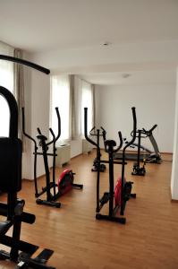a room with a bunch of gym equipment on a wooden floor at Oras Zlatna in Zlatna