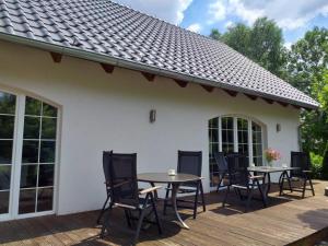 a patio with tables and chairs on a deck at Reha Vital in Stare Siołkowice
