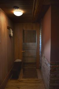 a hallway with a door and a brick wall at Beibuki in Naujene