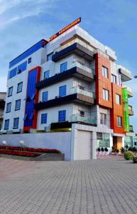 a large building in front of a building at Noahgarden Hotel in Cotonou