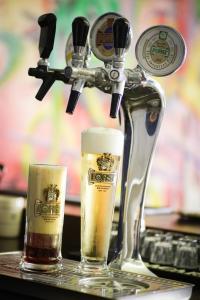dos vasos de cerveza en una barra con un exprimidor en Antica Locanda Cavallino Bianco, en Cerveteri