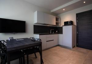 a kitchen with a stove top oven and a microwave at Astoria Living Apartments in Bologna