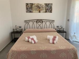 a bedroom with a bed with two pillows on it at B&B Centrale in Tortolì