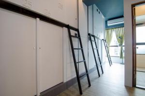 a room with four ladders leaning against a wall at Flying Backpacker in Yilan City