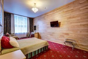 a hotel room with a bed and a flat screen tv at Sunflower River Hotel Moscow in Moscow