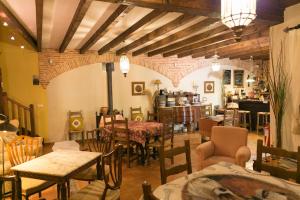 a dining room with tables and chairs and a room with at La Troje Oropesana in Oropesa