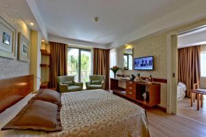 a hotel room with a large bed and a television at Side Star Beach Hotel - Ultra All Inclusive in Side