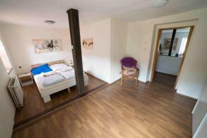 a bedroom with a bed and a mirror in it at Ferienhaus Salmtal Himmerod in Großlittgen