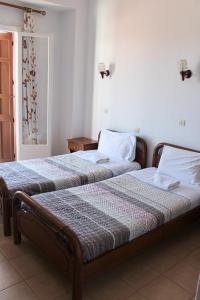 Postel nebo postele na pokoji v ubytování Pantelis Rooms Skopelos