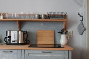 a kitchen with a coffee maker on a counter at Klopstock´s Herberge in Quedlinburg