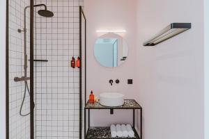 a bathroom with a sink, toilet, and shower stall at Supernova Hotel in Rotterdam