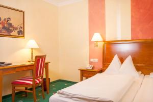Postel nebo postele na pokoji v ubytování Hotel Wilder Mann