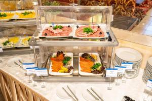 a buffet line with plates of food on display at Sunflower River Hotel Moscow in Moscow