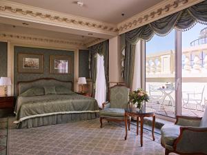 
a living room with a large bed and a large window at Grand Hotel Wien in Vienna
