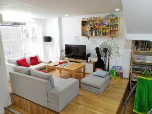 a living room with a couch and a table at Usagiyah Hotel & Guest House in Ho Chi Minh City