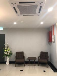 a hospital waiting room with two chairs and a window at K VILA HOTEL in Sungai Petani