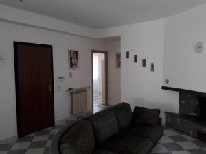 a living room with a couch and a fireplace at La Casa dei Gelsi in Castel Gandolfo