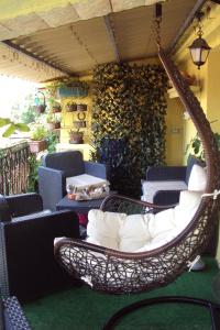 a wicker swing sitting on a patio at B&B Camera & Caffe in Tempio Pausania