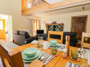 a dining room and living room with a wooden table at The Stables in Hull