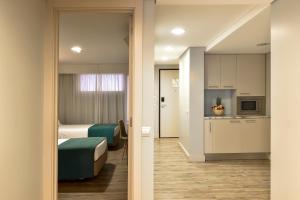 a hotel room with a bed and a kitchen at Aqualuz Lagos by The Editory in Lagos