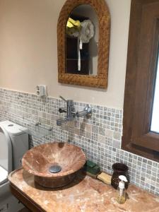 a bathroom with a wooden sink and a mirror at Maison dans les Cévennes in Saint-Hippolyte-du-Fort