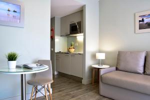 a living room with a couch and a table at Aqualuz Lagos by The Editory in Lagos