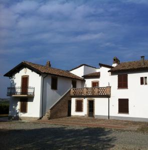 Cette maison blanche dispose d'un balcon sur le côté. dans l'établissement La Locanda, à Calvignano