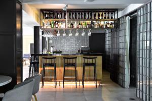 a bar in a restaurant with bar stools at Aqualuz Lagos by The Editory in Lagos