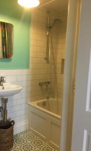 a bathroom with a bath tub and a sink at Number 6 Narrow Water Castle in Warrenpoint