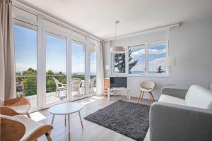 a living room with a couch and a table and chairs at Mirador Balaton Panorama Villa & Jacuzzi in Balatonakarattya +33 photos