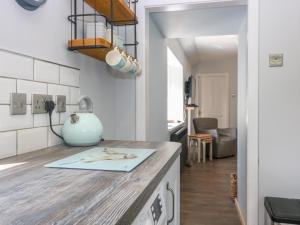 a kitchen with a counter with a vase on it at 2 Tougal in Mallaig