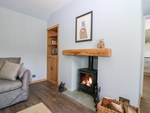 a living room with a fireplace and a couch at 2 Tougal in Mallaig